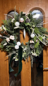 white and green large christmas door wreath